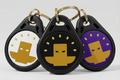 Three black keychains with gold and purple designs on a white background used to lock in with Totem Focus.