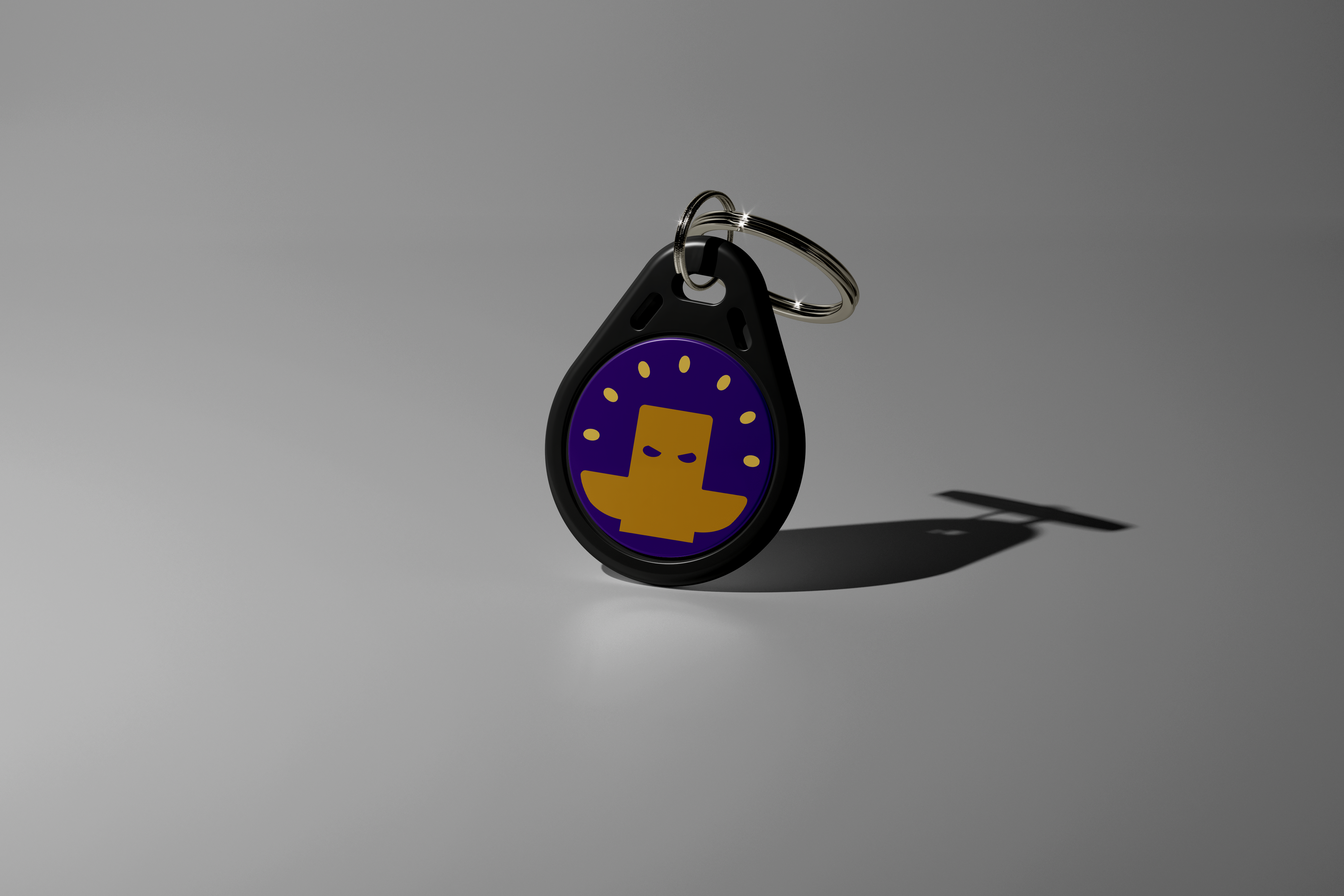 Our purple keychain Totem with a yellow logo on a gray background. Used to aid focus for ADHD and students. Totem Focus.